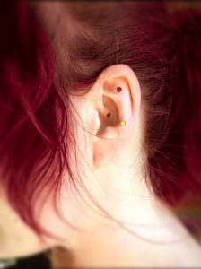 Acupuncturist, Katharine Chaney, modeling jeweled ear magnets