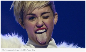 White woman with short blond hair sticking out her tongue