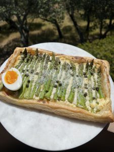 Pastry topped with asparagus and soft boiled egg